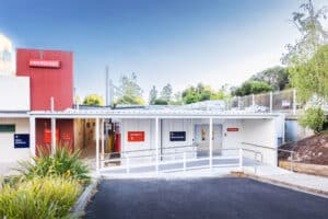 Emergency department entrance with ramp, Emergency and Main Entrance signs at hospital
