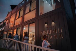Kirribilli Harbour event venue with people gathered at dusk